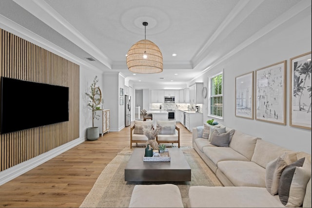 17564 Cinquez Park Rd W, Jupiter, FL 33458 - living area featuring light wood-style floors, ornamental molding, a tray ceiling, recessed lighting, and baseboards