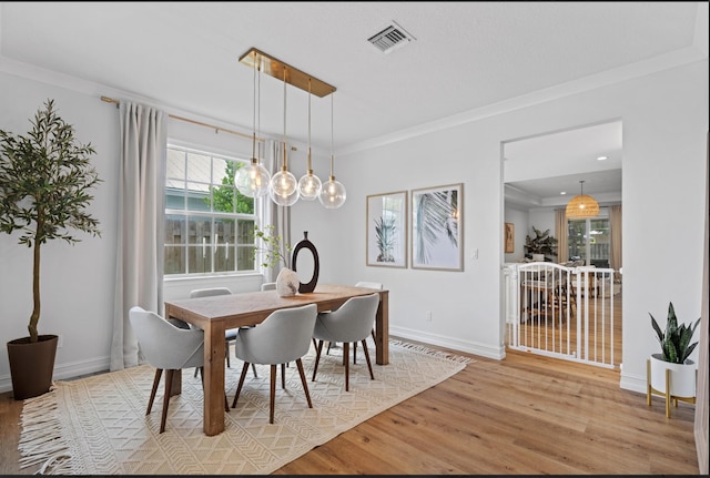 17564 Cinquez Park Rd W, Jupiter, FL 33458 - dining area featuring wood finished floors, ornamental molding, and baseboards