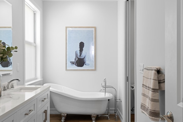 17564 Cinquez Park Rd W, Jupiter, FL 33458 - full bathroom with vanity, a soaking tub, and wood finished floors