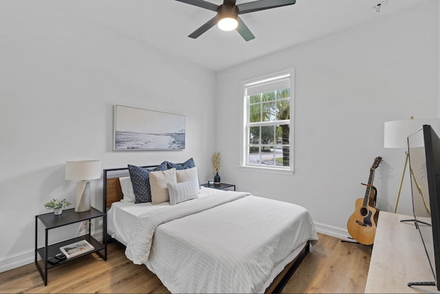 17564 Cinquez Park Rd W, Jupiter, FL 33458 - bedroom featuring wood finished floors, baseboards, and a ceiling fan