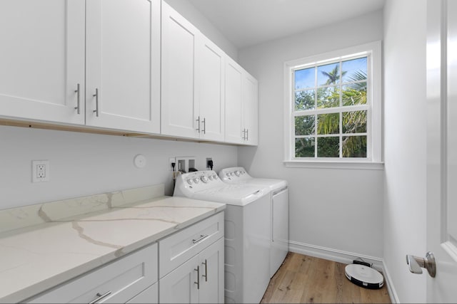 17564 Cinquez Park Rd W, Jupiter, FL 33458 - washroom featuring cabinet space, light wood-style flooring, washer and clothes dryer, and baseboards