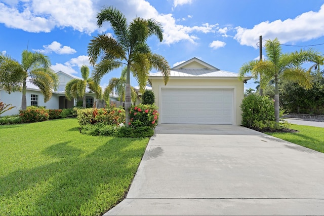 17564 Cinquez Park Rd W, Jupiter, FL 33458 - single story home featuring a front lawn, driveway, an attached garage, and stucco siding