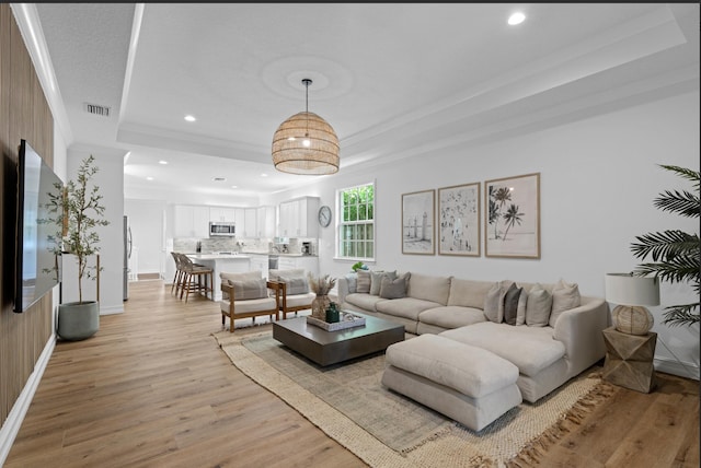 17564 Cinquez Park Rd W, Jupiter, FL 33458 - living area with recessed lighting, a tray ceiling, light wood finished floors, ornamental molding, and baseboards