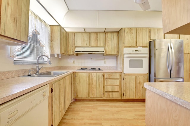5730 Fernley Dr E Unit 28, West Palm Beach, FL 33415 - kitchen featuring white appliances, a sink, light brown cabinets, and light wood-style floors
