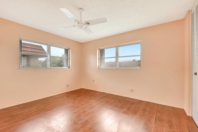 5730 Fernley Dr E Unit 28, West Palm Beach, FL 33415 - unfurnished bedroom featuring multiple windows, a closet, wood finished floors, and baseboards