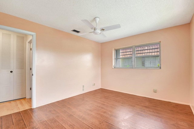 5730 Fernley Dr E Unit 28, West Palm Beach, FL 33415 - unfurnished room featuring a ceiling fan, wood finished floors, and a textured ceiling