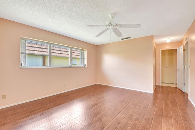 5730 Fernley Dr E Unit 28, West Palm Beach, FL 33415 - unfurnished room featuring wood finished floors, ceiling fan, baseboards, and a textured ceiling