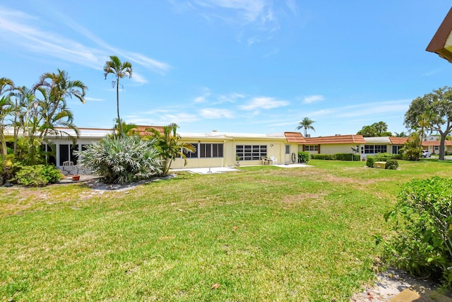 5730 Fernley Dr E Unit 28, West Palm Beach, FL 33415 - rear view of house with a yard and a patio