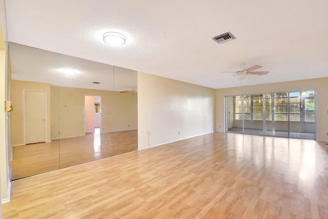 5730 Fernley Dr E Unit 28, West Palm Beach, FL 33415 - empty room featuring a ceiling fan, light wood-style flooring, baseboards, and a textured ceiling