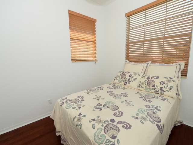 bedroom featuring baseboards and wood finished floors