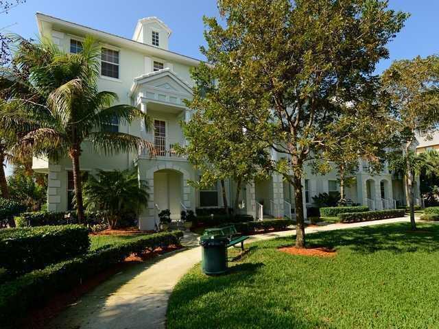 view of front of home with a front yard, stucco siding, and a balcony