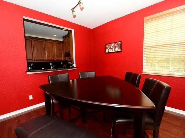 dining room featuring baseboards, wood finished floors, and track lighting