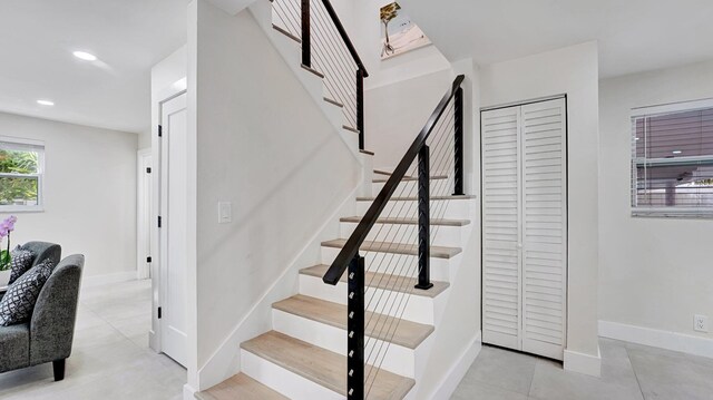 218 NE 10th St, Delray Beach, FL 33444 - staircase featuring tile patterned floors, baseboards, and recessed lighting