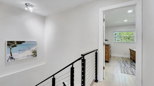 218 NE 10th St, Delray Beach, FL 33444 - hall featuring an upstairs landing, light wood-type flooring, recessed lighting, and baseboards