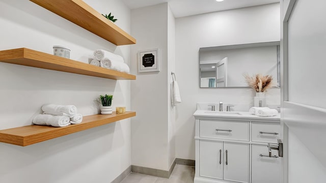 218 NE 10th St, Delray Beach, FL 33444 - bathroom featuring vanity, baseboards, and tile patterned floors