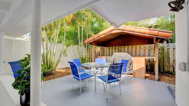 218 NE 10th St, Delray Beach, FL 33444 - fenced backyard featuring outdoor dining space and a patio