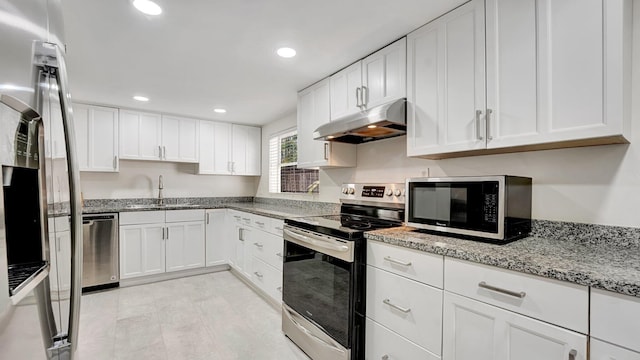 218 NE 10th St, Delray Beach, FL 33444 - kitchen with appliances with stainless steel finishes, under cabinet range hood, a sink, white cabinets, and recessed lighting