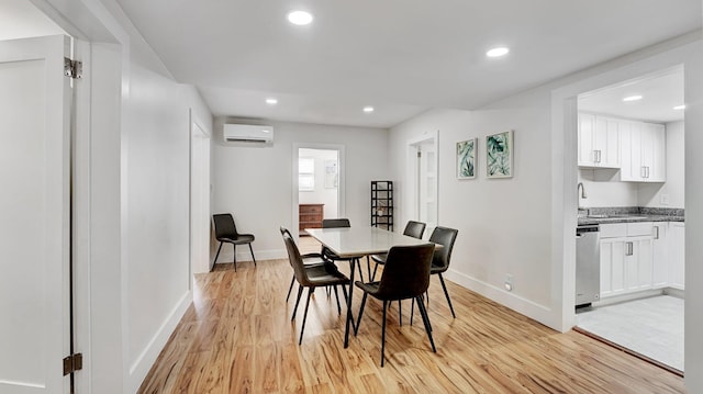 218 NE 10th St, Delray Beach, FL 33444 - dining area featuring an AC wall unit, light wood-style floors, baseboards, and recessed lighting