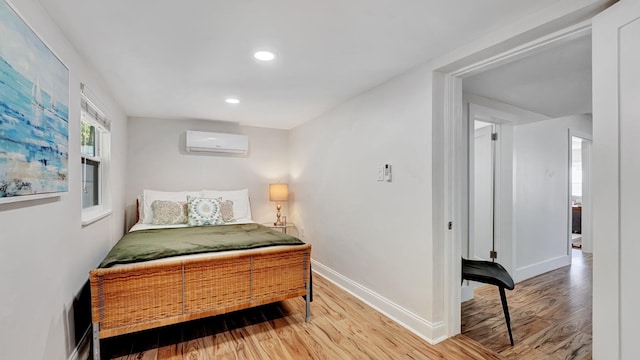 218 NE 10th St, Delray Beach, FL 33444 - bedroom featuring a wall mounted air conditioner, wood finished floors, baseboards, and recessed lighting