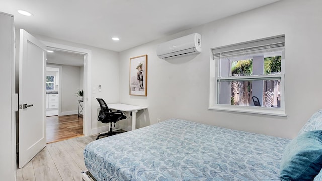 218 NE 10th St, Delray Beach, FL 33444 - bedroom featuring an AC wall unit, light wood finished floors, recessed lighting, and baseboards