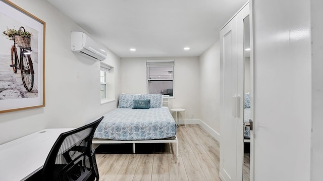 218 NE 10th St, Delray Beach, FL 33444 - bedroom with a wall mounted AC, light wood-style floors, recessed lighting, and baseboards