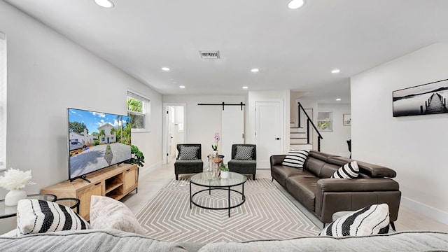 218 NE 10th St, Delray Beach, FL 33444 - living area featuring recessed lighting, a barn door, stairway, and baseboards
