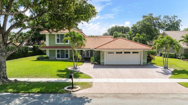 2850 NW 26th Ct, Boca Raton, FL 33434 - view of front of house featuring decorative driveway, a tile roof, a garage, french doors, and stucco siding