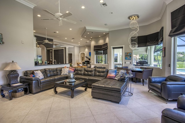 living area with a ceiling fan, ornamental molding, light tile patterned floors, and recessed lighting