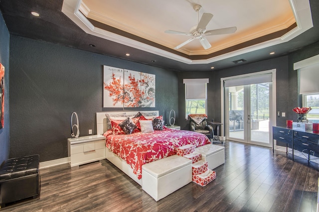 bedroom featuring ornamental molding, a tray ceiling, access to exterior, dark wood-type flooring, and a textured wall