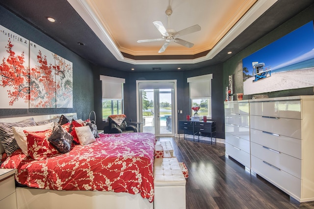 bedroom featuring a tray ceiling, crown molding, access to exterior, wood finished floors, and baseboards