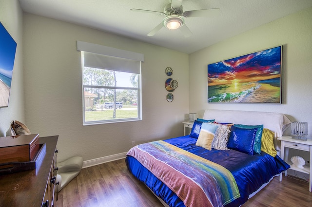 bedroom featuring wood finished floors, baseboards, and a ceiling fan