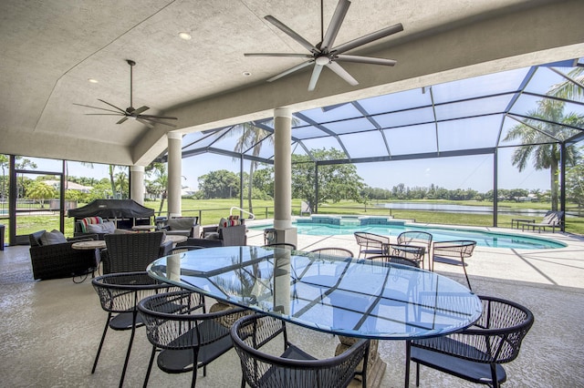 view of patio / terrace featuring ceiling fan, outdoor dining space, an outdoor hangout area, a pool with connected hot tub, and a lanai