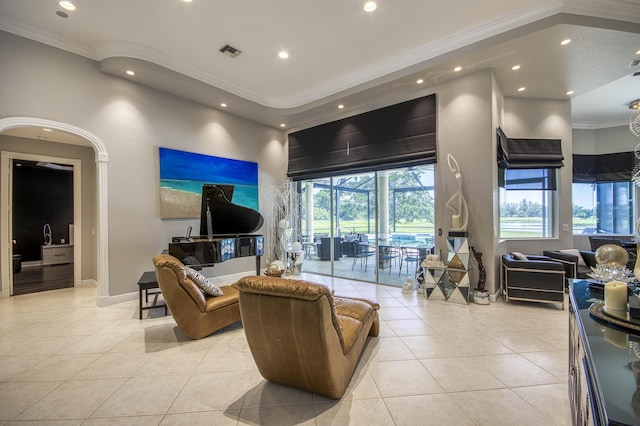 living room with crown molding, light tile patterned floors, recessed lighting, and baseboards