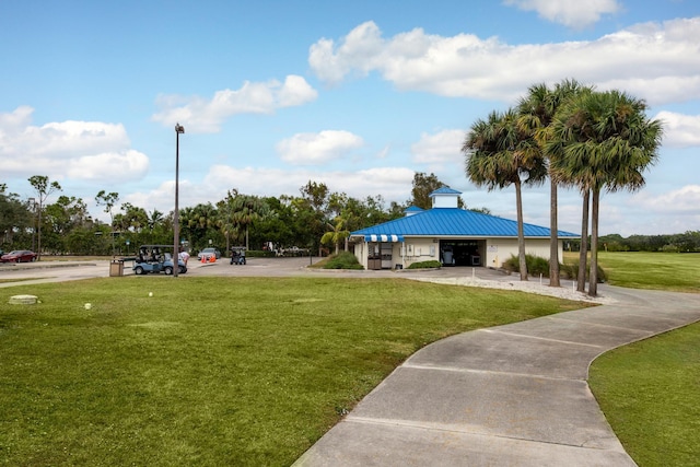 view of property's community with a lawn and a garage