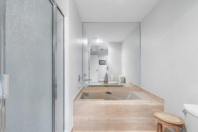 65 Eastgate Dr Unit B, Boynton Beach, FL 33436 - bathroom featuring toilet, a shower stall, a garden tub, and a sink
