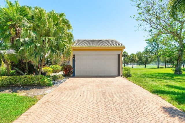 65 Eastgate Dr Unit B, Boynton Beach, FL 33436 - garage featuring decorative driveway
