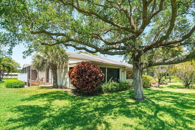65 Eastgate Dr Unit B, Boynton Beach, FL 33436 - view of side of property featuring a yard and a sunroom