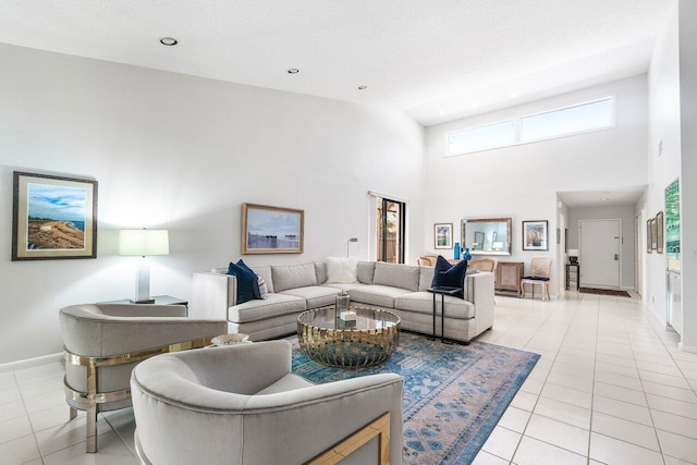 65 Eastgate Dr Unit B, Boynton Beach, FL 33436 - living room with light tile patterned floors, baseboards, a towering ceiling, and recessed lighting