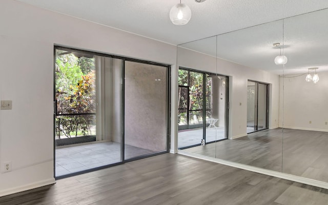 5640 Coach House Cir Unit C, Boca Raton, FL 33486 - unfurnished room with wood finished floors, a textured ceiling, and baseboards