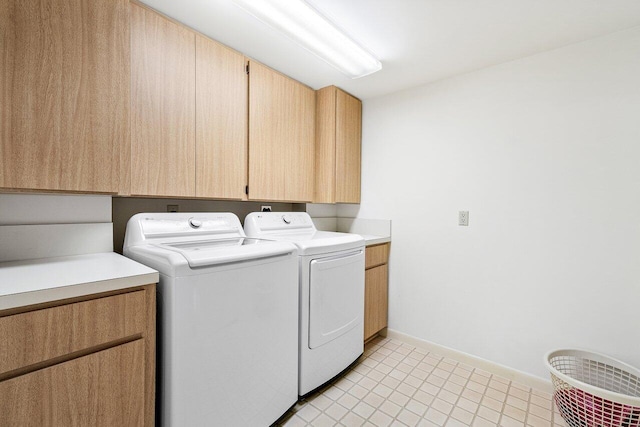 1401 Tidal Pointe Blvd Unit 405, Jupiter, FL 33477 - laundry area with washing machine and dryer, cabinet space, baseboards, and light tile patterned floors