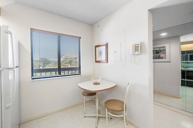 1401 Tidal Pointe Blvd Unit 405, Jupiter, FL 33477 - dining area with baseboards, a textured ceiling, and recessed lighting