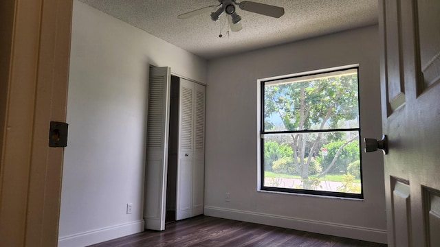164 Meadows Dr, Boynton Beach, FL 33436 - unfurnished bedroom with a textured ceiling, dark wood finished floors, a closet, and ceiling fan