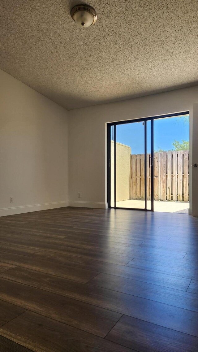 164 Meadows Dr, Boynton Beach, FL 33436 - empty room featuring dark wood-style flooring and a textured ceiling