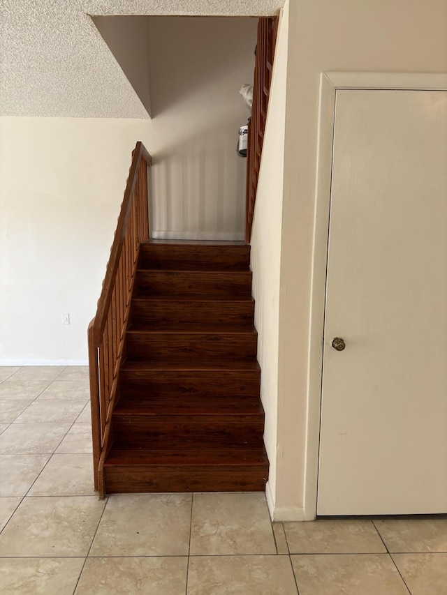 4505 45th Way, West Palm Beach, FL 33407 - staircase with tile patterned floors, baseboards, and a textured ceiling