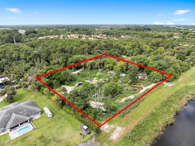 69 Armadillo Way, West Palm Beach, FL 33411 - aerial view of property and surrounding area with property parcel outlined and a heavily wooded area