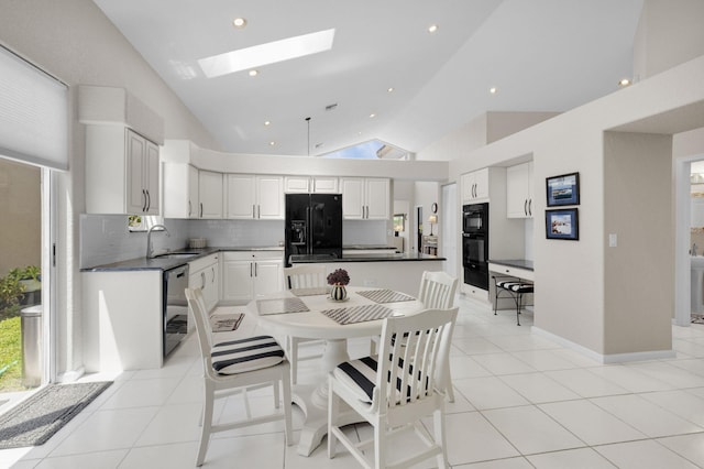 6179 Evian Pl, Boynton Beach, FL 33437 - dining area featuring a skylight, vaulted ceiling, light tile patterned flooring, and recessed lighting
