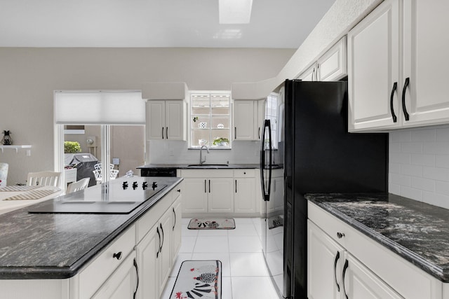 6179 Evian Pl, Boynton Beach, FL 33437 - kitchen featuring a sink, black appliances, plenty of natural light, and decorative backsplash