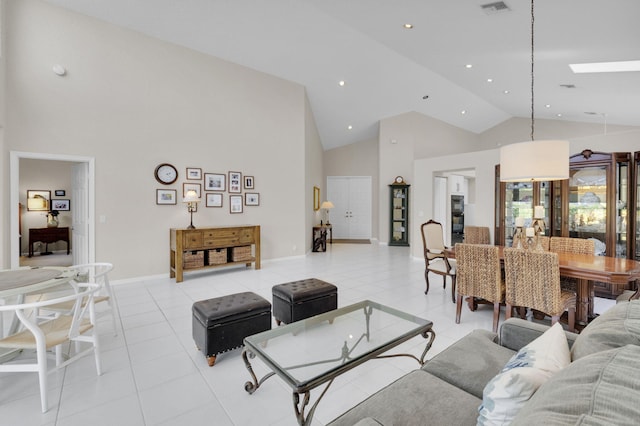 6179 Evian Pl, Boynton Beach, FL 33437 - living room featuring high vaulted ceiling, light tile patterned floors, recessed lighting, a skylight, and baseboards