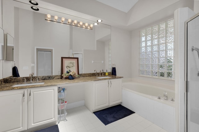 6179 Evian Pl, Boynton Beach, FL 33437 - full bathroom featuring a garden tub, double vanity, a shower stall, and tile patterned flooring