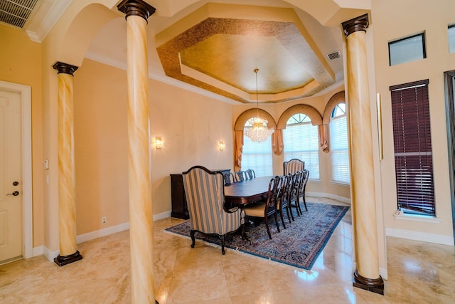 8979 Three Rail Dr, Boynton Beach, FL 33472 - dining area with decorative columns, ornamental molding, a chandelier, baseboards, and a tray ceiling